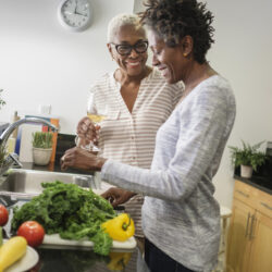 Two older women cooking together