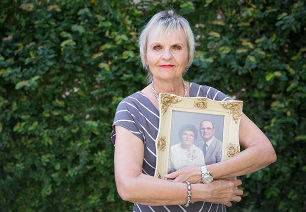 Older woman holding picture frame