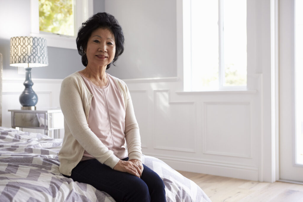 Portrait Of Senior Woman In Bedroom Of Home