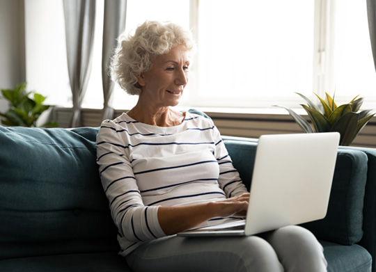 Older woman on laptop looking to search by outcome
